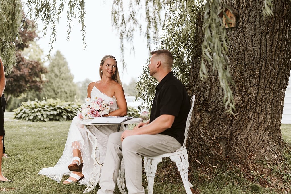 a blog post our wedding story signing the paper under a willow tree