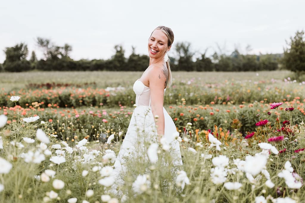 blog post our wedding story bride dancing in flower field