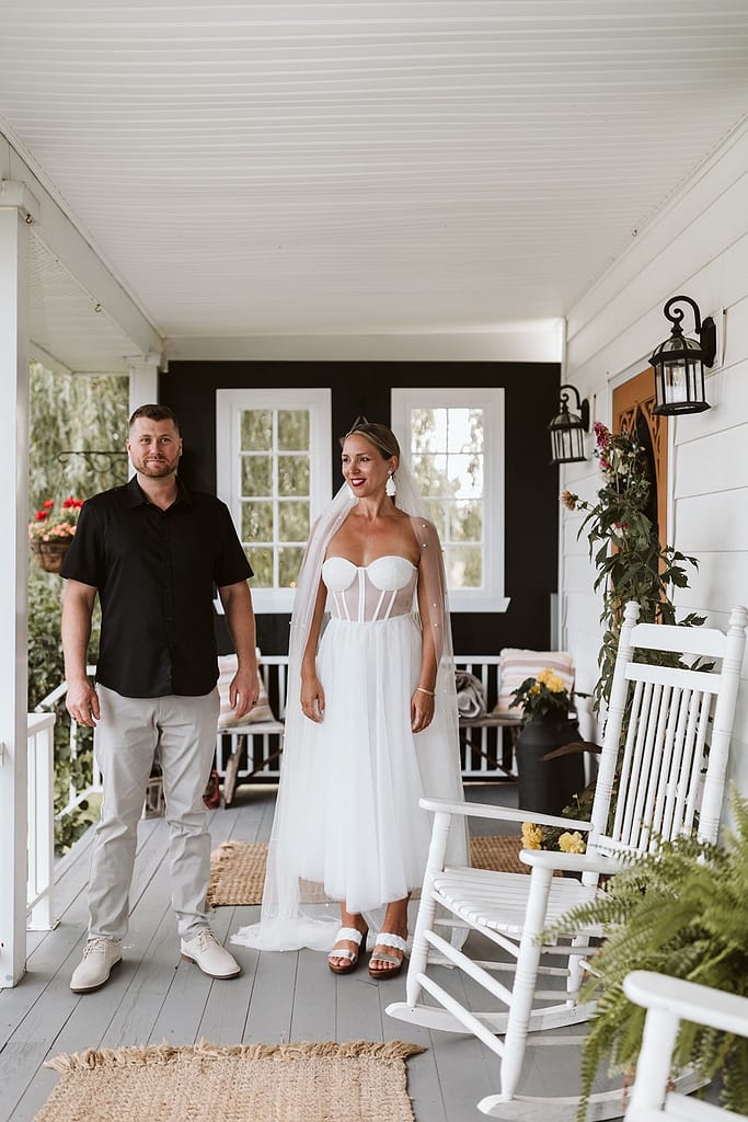 blog post our wedding story bride and groom on front porch of farmhouse