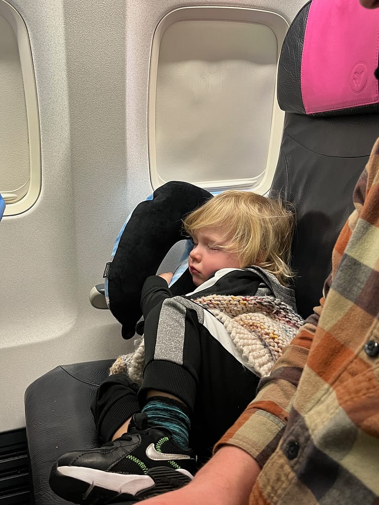 travelling after kids - toddler sleeping on airplane